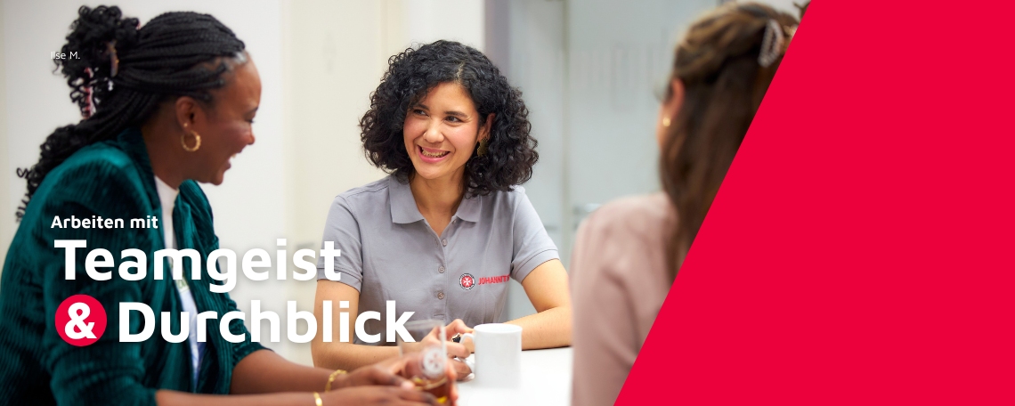 Drei Frauen sitzen gemeinsam an einem Tisch in einem hellen Büro. Sie unterhalten sich freundlich und lachen. Eine Frau in der Mitte trägt ein graues Poloshirt mit dem Logo der Johanniter. Links im Bild steht der Name „Ilse M.“ mit dem Titel „Sachbearbeit